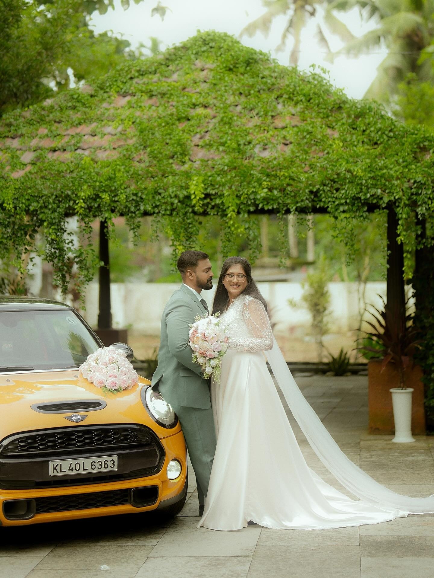 A bride smiling while holding her pastel bouquet